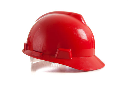 A red construction workers helmet on a white backgroundの写真素材
