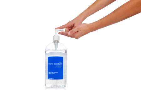 A child's hand dispensing hand sanitizer - swine flu prevention theme - on a white background with copy spaceの写真素材