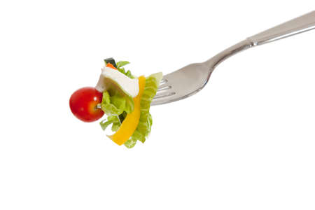 a vegetable salad on a fork with a white backgroundの写真素材