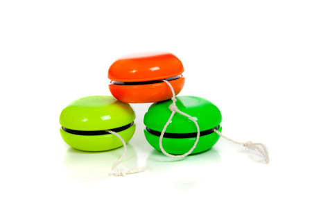 Green and red yoyos on a white background with copy spaceの写真素材