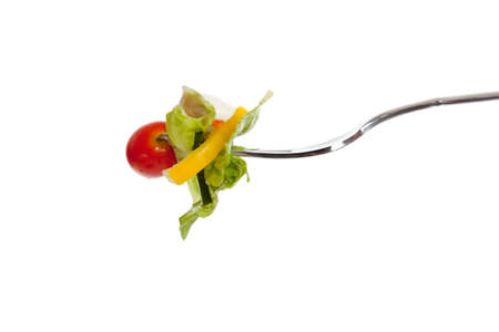a vegetable salad on a fork with a white backgroundの写真素材