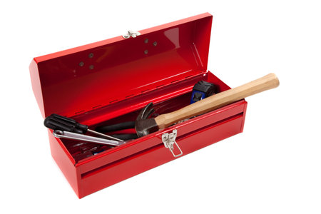 A red metal toolbox with tools on a white backgroundの写真素材