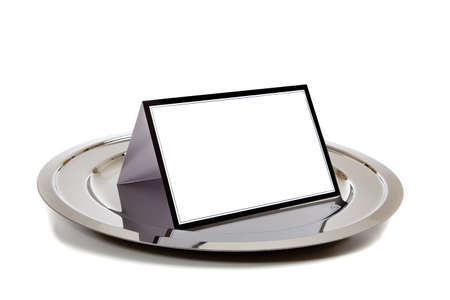 Blank white notebook lined in black on a silver tray on a white backgroundの写真素材