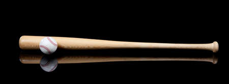 Wooden baseball and bat on a black backgroundの写真素材