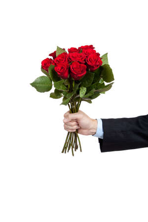 A man's hand holidng a dozen red roses on a white background with copy spaceの写真素材