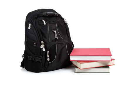 A  black backpack with text books on a white background with copy spaceの写真素材