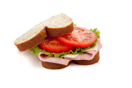 Ham sandwich  with lettuce and tomato on wheat bread on a white backgroundの写真素材
