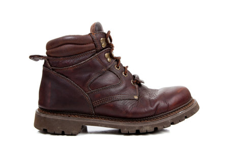 A brown leather hiking boot on a white background