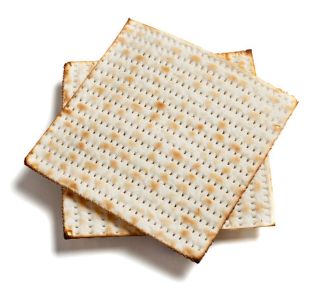 Two pieces of matza bread on a white background