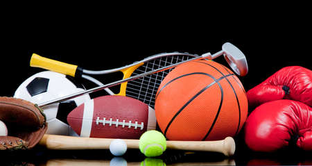 Assorted sports equipment including a basketball, soccer ball, tennis ball, golf ball, bat tennis racket, boxing gloves, football, golf and baseball glove