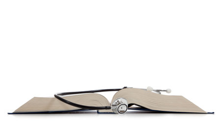 A medical reference book with a stethoscope on a white backgroundの写真素材