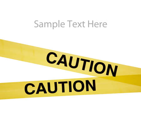 Yellow caution tape on a white background with copy spaceの写真素材