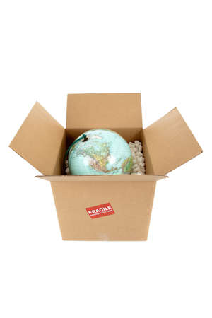 A world globe in a packing box with a fragile sticker on a white backgroundの写真素材