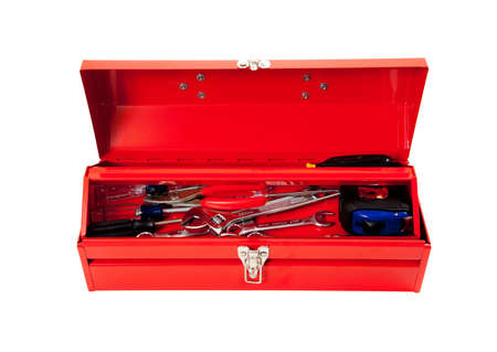 Red metal tool box with tools including hammer, tape measure, wrench, screwdriver on a white backgroundの写真素材