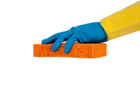 A blue and yellow rubber gloved hand holding an orange sponge on a white background with copy spaceの写真素材