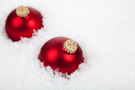 Red Christmas ball ornaments/baubles on a white background with copy spaceの写真素材
