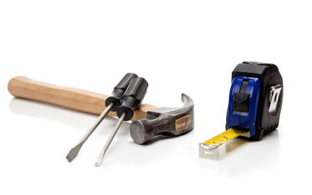 A hammer, screwdrivers and a tape measure on a white backgroundの写真素材
