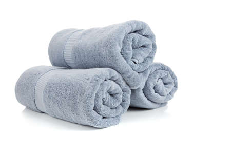Three rolled gray towels on a white backgroundの写真素材