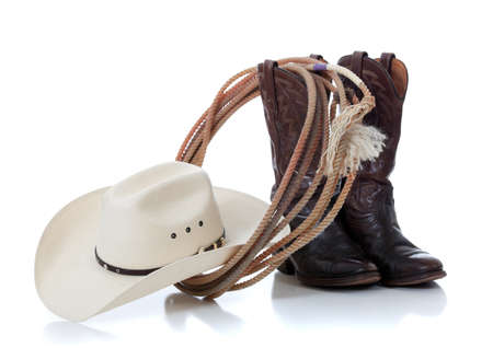 A white cowboy hat, brown leather boots and lariat on a white backgroundの写真素材