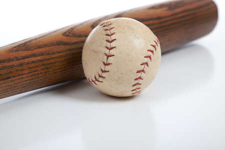 An antique baseball bat and ball on a white backgroundの写真素材