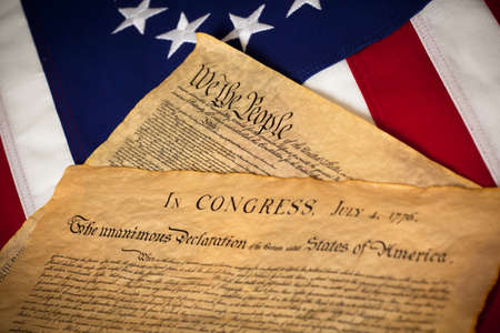 the United States Constitution and Declaration of Independence on a Betsy Ross Flag backgroundの写真素材