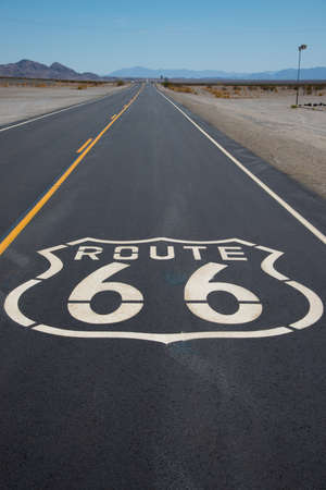 A route 66 highway shield painted on a new road in the California desertの写真素材