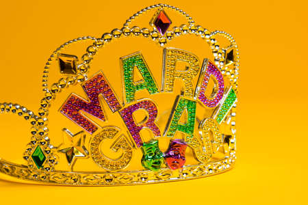 A jeweled Mardi Gras crown on a yello backgroungの写真素材