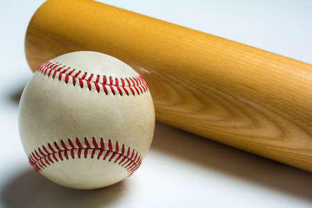 A wooden baseball bat and ball on a whiteの写真素材