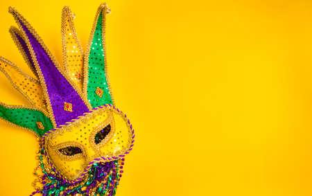 A venetian, mardi gras mask or disguise on a yellow backgroundの写真素材