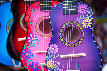 A group of colorful painted mexican made guitarsの写真素材