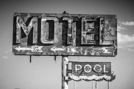 A dilapidated, vintage motel sign in the desert of Arizonaの写真素材