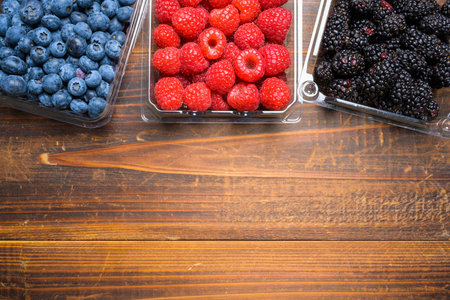 Assorted Berries on wood background