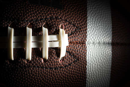 Close-up of an American football on black backgroundの写真素材