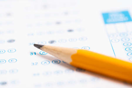 A yellow pencil on a computer read testの写真素材