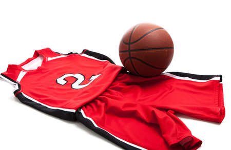 Red basketball uniform on white background with leather ballの写真素材