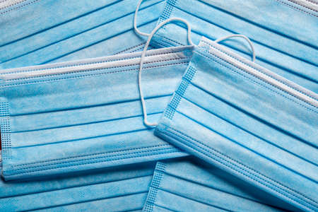 A stack of blue paper surgical masks. COVID, virus themeの写真素材