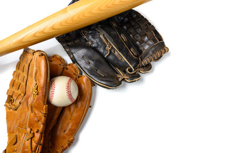 Leather baseball gloves with a ball and a bat on whiteの写真素材