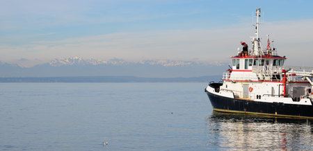 A firefighting boat in the Seattle harbor at Puget Sound with the Olympic mountains in background