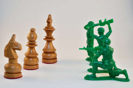 Chess pieces vs. Army men toysの写真素材