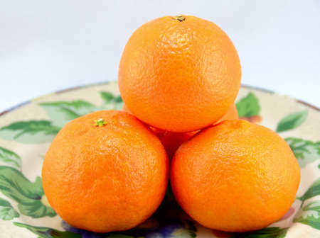 Four Clementine Oranges on a plateの写真素材