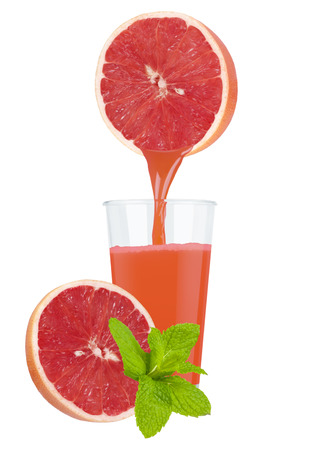 Glass of fresh grapefruit juice with grapefruit on a white backgroundの写真素材