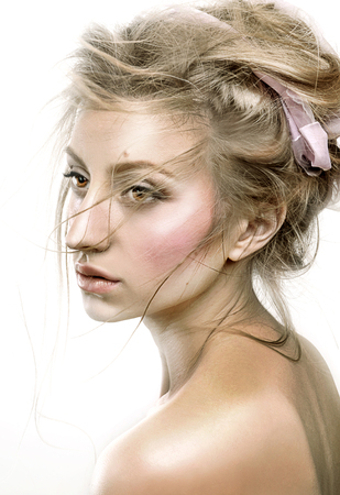 Beautiful face woman with fresh daily makeup. Beauty Portrait of model with shiny skin, and romantic wavy hair.の写真素材
