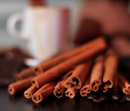 Cup of coffee and cinnamon on wood tableの写真素材