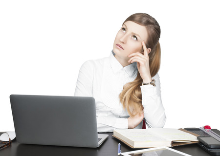 Successful business woman in white shirt, secretary sitting for table using laptop computer in officeの写真素材