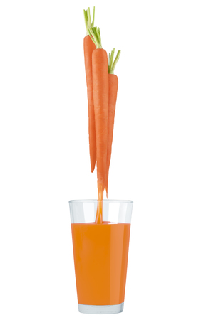 Conceptual image - fresh carrot juice is flowing into the glass.の写真素材