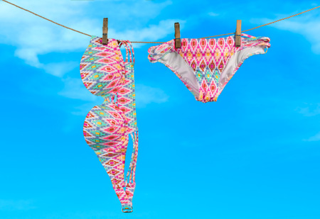 Summer vacation on the beach, swimwear on sky backgroundの写真素材