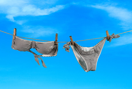 Summer vacation on the beach, swimwear on sky backgroundの写真素材