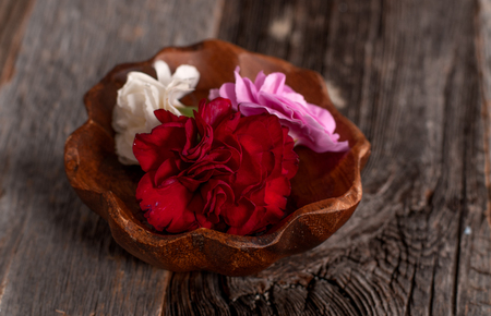 Beautiful Flowers in wooden bowl. Spa Conceptの写真素材