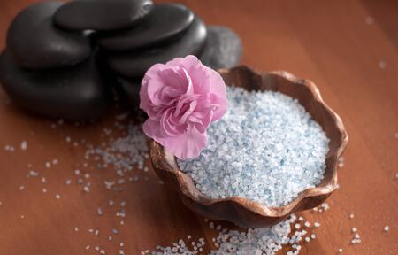 Spa and wellness setting with sea salt and stones for massage. の写真素材