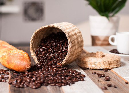 Coffee beans and bread on wood tableの写真素材